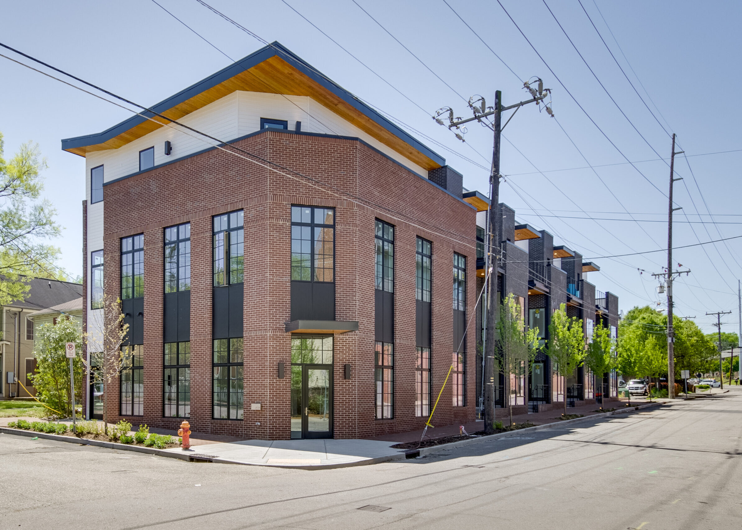 The exterior of a condo building with red and black brick.